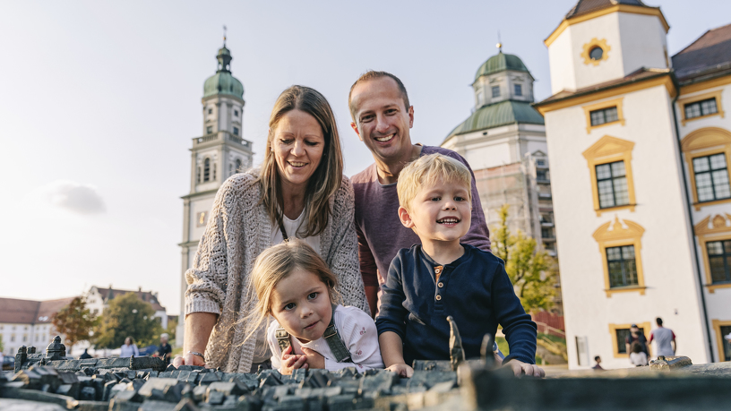 Family holiday in kempten at the city relief in front of the residence and the Basilica of St Lorenz