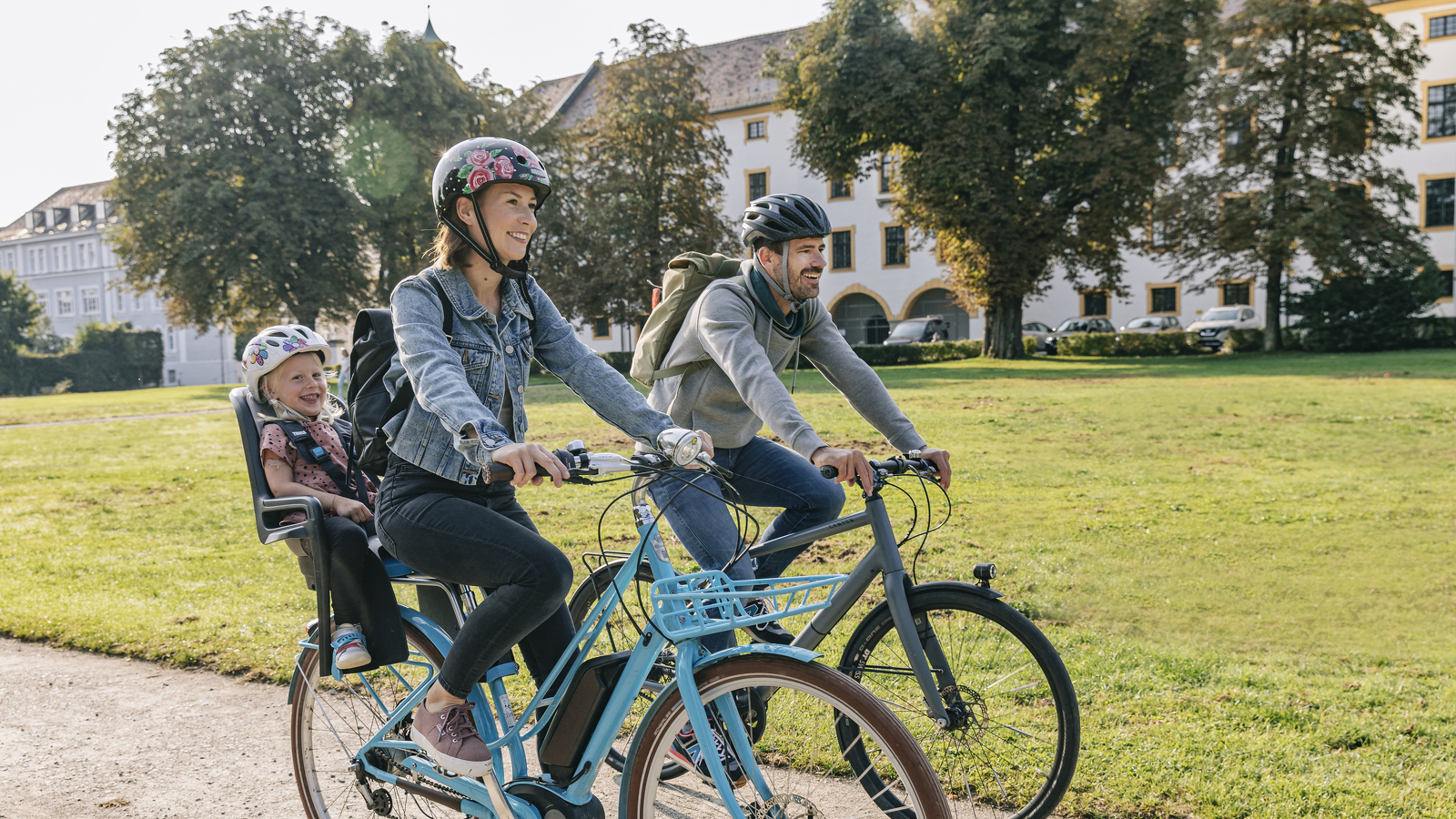 A family cycling in the courtyard garden