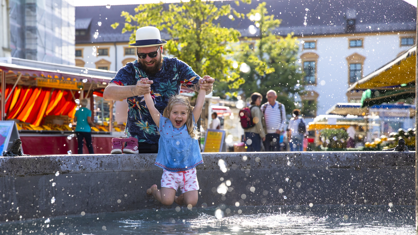 People playing at the fountain