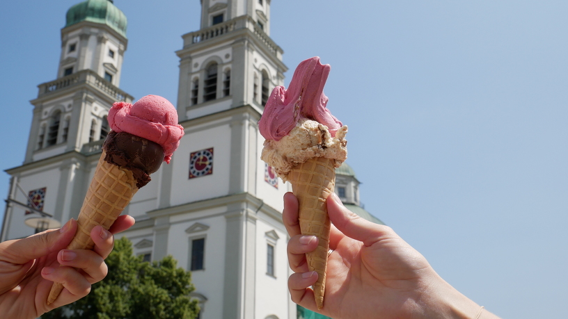 Two waffles with ice cream in front of Basilica of St Lorenz