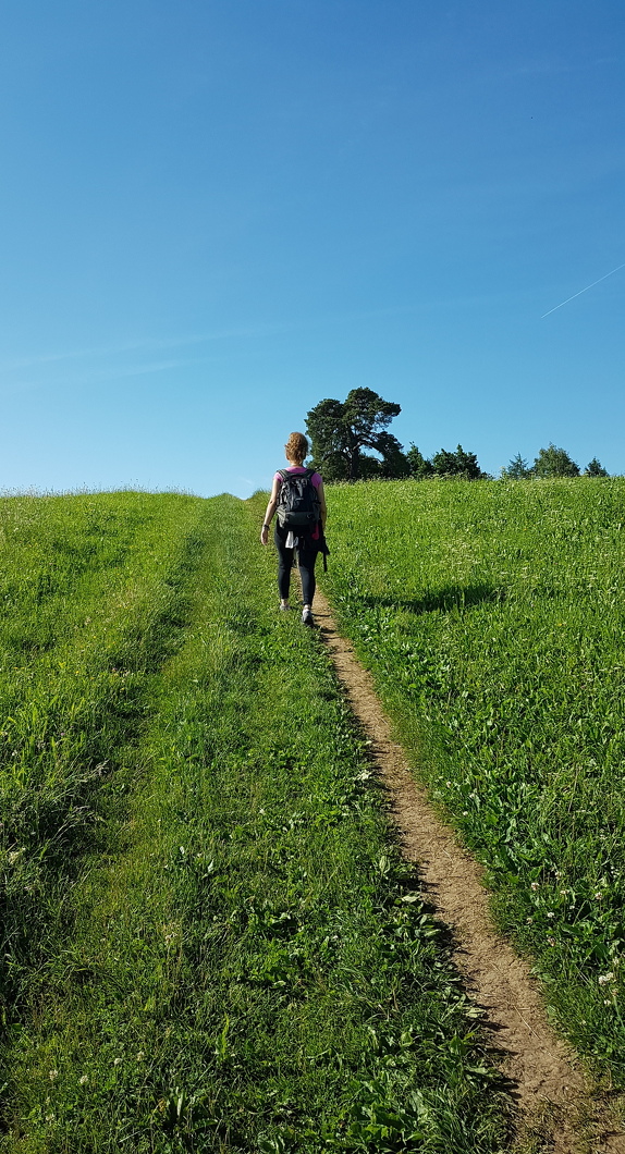 A woman hiking in a meadow