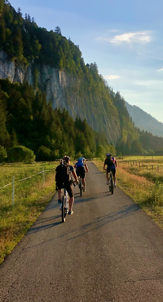 Three people riding a bicycle