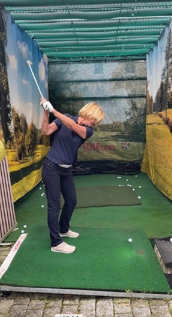 A woman makes a golf swing