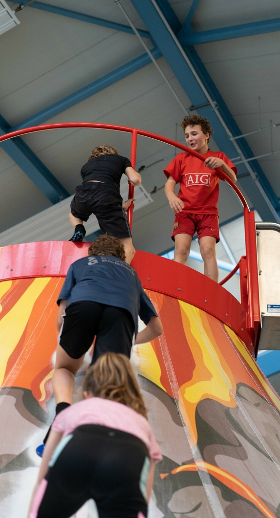 Children climb up a scaffold